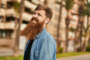 Wall Mural - Young irish hipster man smiling happy standing at the city.