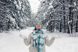 © Natasha  - A girl stands in the winter forest, cheerfully throws up the snow in white mittens