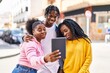 © Krakenimages.com - African american friends standing together having video call at street
