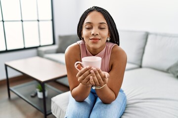 Canvas Print - Young african american woman smiling confident drinking coffee at home