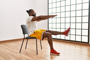 Wall Mural - Young african american man training at sport center