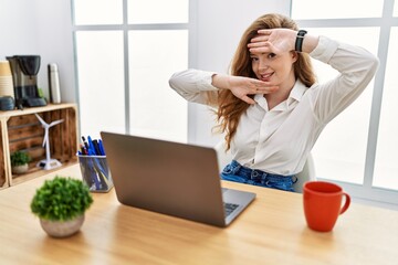 Sticker - Young caucasian woman working at the office using computer laptop smiling cheerful playing peek a boo with hands showing face. surprised and exited