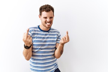 Poster - Handsome young man standing over isolated background showing middle finger doing fuck you bad expression, provocation and rude attitude. screaming excited