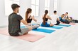 © Krakenimages.com - Group of young people having yoga class with personal trainer at sport center.