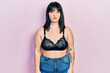 © Krakenimages.com - Young hispanic woman wearing lingerie with serious expression on face. simple and natural looking at the camera.