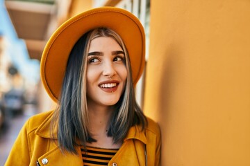 Wall Mural - Young caucasian girl smiling happy standing at the city.