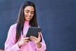 © Krakenimages.com - Young hispanic woman smiling confident using touchpad at street