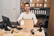 © Krakenimages.com - Young hispanic man with beard working at small business ecommerce holding box celebrating crazy and amazed for success with open eyes screaming excited.