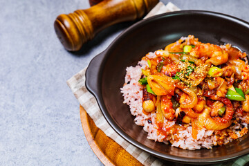 Wall Mural - Nakjideopbap, Korean style spicy stir-fried octopus over rice : This dish is made by stir-frying sliced onion and carrots along with sauce over high heat in an oiled pan. Bite-sized pieces of octopus 