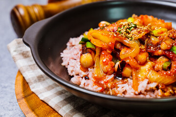 Wall Mural - Nakjideopbap, Korean style spicy stir-fried octopus over rice : This dish is made by stir-frying sliced onion and carrots along with sauce over high heat in an oiled pan. Bite-sized pieces of octopus 