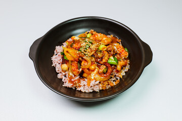 Wall Mural - Nakjideopbap, Korean style spicy stir-fried octopus over rice : This dish is made by stir-frying sliced onion and carrots along with sauce over high heat in an oiled pan. Bite-sized pieces of octopus 