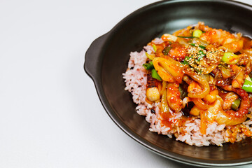 Wall Mural - Nakjideopbap, Korean style spicy stir-fried octopus over rice : This dish is made by stir-frying sliced onion and carrots along with sauce over high heat in an oiled pan. Bite-sized pieces of octopus 