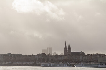 Panorama of the garonne quay (quais de la garonne), in Bordeaux, France, with the Saint Andre Cathedral behind during a winter afternoon sunset. Bordeaux is the main French southwestern city.....