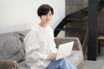 Wall Mural - Beautiful woman working on computer in her room.