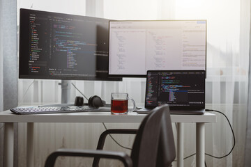 Wall Mural - interior shot. workplace of a programmer, it job, home, computer monitors and laptop on desk