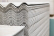 Sheets of construction slate in a stack. Asbestos cement corrugated sheets of roofing material. Building materials.