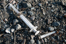 Used Drug Syringe On The Ground