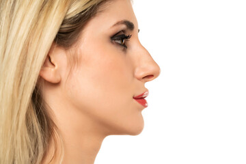 Wall Mural - Profile portrait of a young woman with a humpbacked nose on a white background