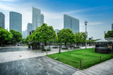Fototapeta Londyn - Street scene with green grass and modern buildings