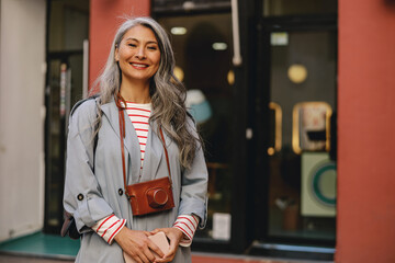 Wall Mural - Confident woman with happy face posing outdoors