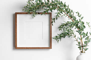 Wall Mural - Square frame mockup in white room interior with fresh eucalyptus plant in vase