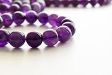 Amethyst Gemstone Bracelet On The Table. Purple Or Violet Crystal Stone On White Background.