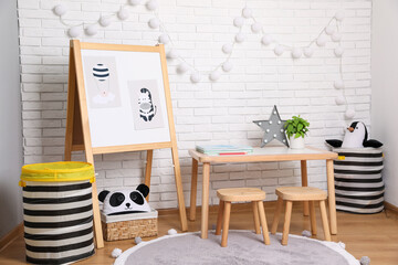 Wall Mural - Stylish child room interior with wooden table and board near white brick wall