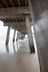 Wall Mural - Ocean waves under a wooden fishing pier