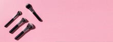 Various Make-up Brushes On Pink Background, Top View Banner And Place For Advertising - Cosmetics And Beauty Concept.
