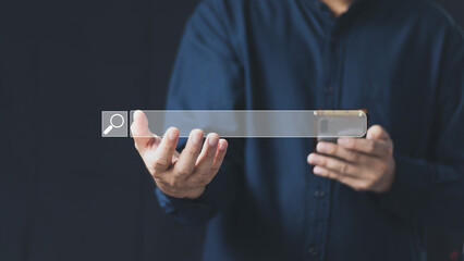 Wall Mural - The concept of using technology to search for information, a man's hand is using a smartphone to search for information on social media via the Internet online.