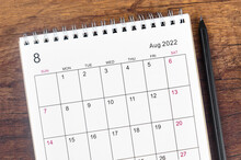 August 2022 Desk Calendar On Wooden Table.