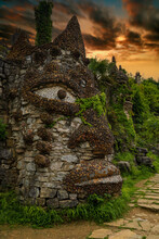 Ancient Stone Human Face Under Dramatic Sky
