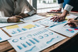 © Natee Meepian - Business team working with financial plan, meeting, discussion, brainstrom with tablet on office desk, Meeting concept