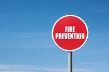 'Fire Prevention' Sign In Red Round Frame. Clear Blue Sky Is On Background