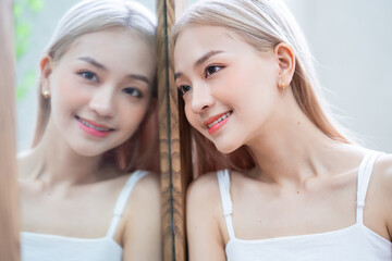 Poster - Portrait of young asian girl and her reflection in the mirror