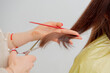 hairdresser cut a hair with scissors