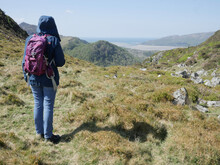 Woman Hiker In The Welsh Grampian Mountains Looking Towards Barmouth In A Thoughtful And Aspirational Way