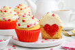 Festive cupcakes with a heart inside for Valentine's Day decorated with sprinkles with hearts. Selective focus.