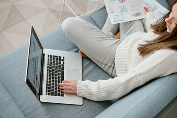 Wall Mural - woman using a laptop to work with financial data .