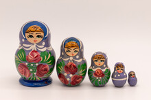 5 Vintage Purple Russian Nesting Dolls (Matryoshka) With Pink Rose Details On White Background