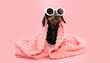 Dog summer bathing. Dachshund puppy wrapped with a coral towel and wearing sunglasses and funny expression. Isolated on pink background