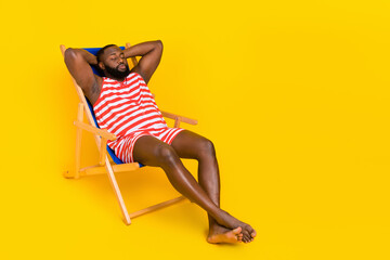 Wall Mural - Photo guy sit deck chair sleep sun bathing wear red striped stylish trendy swim set isolated bright color background