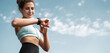 Female portrait athlete uses a watch Pulse measurement outdoor workout Fitness Cardio