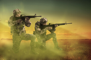 Wall Mural - Soldiers with machine guns on battlefield. War conflict