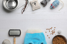 Flat Lay Composition With Cat Clothes, Food And Accessories On White Wooden Table. Space For Text