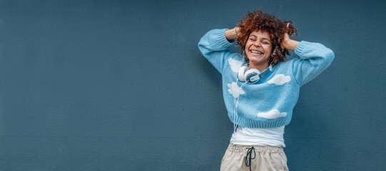 Wall Mural - african american girl isolated on street wall laughing out loud