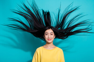 Photo of funny pretty lady dressed yellow sweater smiling wind blowing isolated turquoise color background