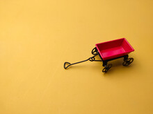 Miniature Garden Metal And Gold Bar On A Yellow Background With Copy Space.