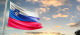 Fototapeta  - Slovenia national flag cloth fabric waving on the sky - Image