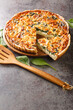 Spinach and herb Florentine quiche for breakfast closeup in the table. Vertical